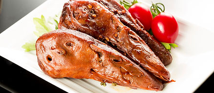 roasted duck heads on white plate