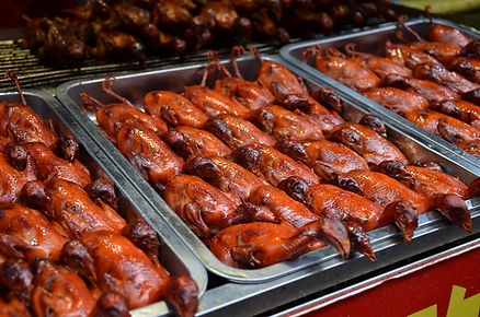 dozens of rows of roasted small birds